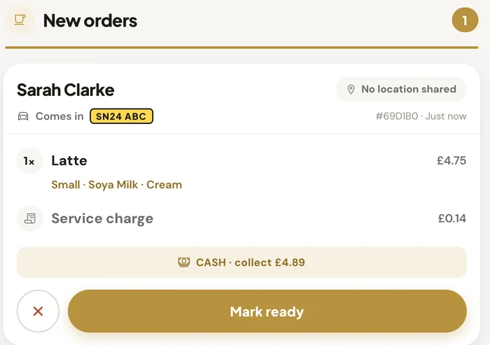 Close-up of a new order on the counter screen: Sarah Clarke, comes in SN24 ABC, one small soya latte with cream, Mark ready button