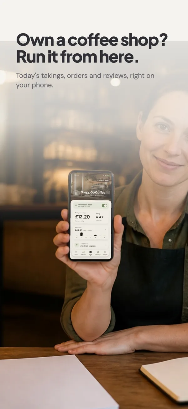 Own a coffee shop? Run it from here.: A café owner holding the SnappGo owner app
